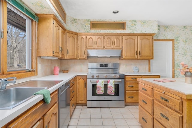 kitchen with stainless steel appliances, light tile patterned floors, tasteful backsplash, and sink