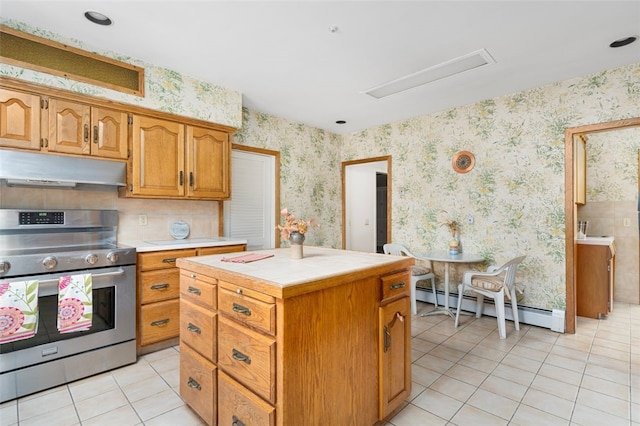 kitchen with baseboard heating, tile counters, light tile patterned floors, a kitchen island, and stainless steel range with electric cooktop