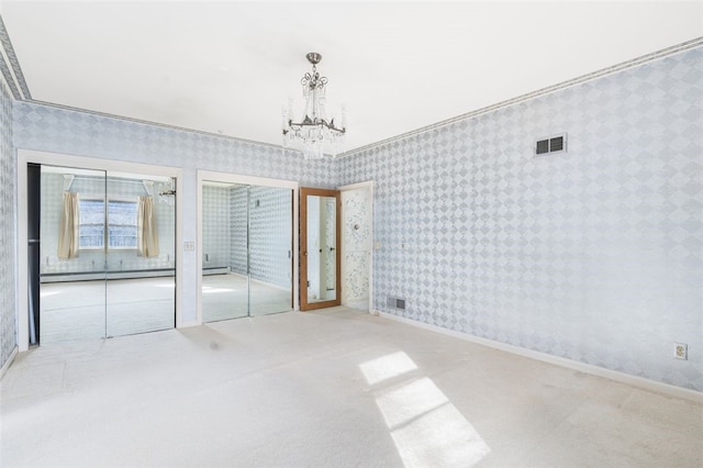 unfurnished room with light carpet, baseboard heating, a chandelier, and crown molding