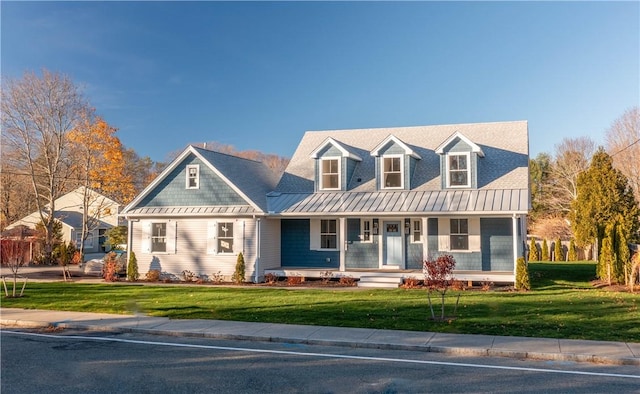 new england style home with covered porch and a front lawn