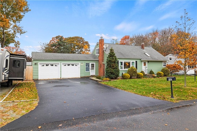 view of front of property with a front yard and a garage