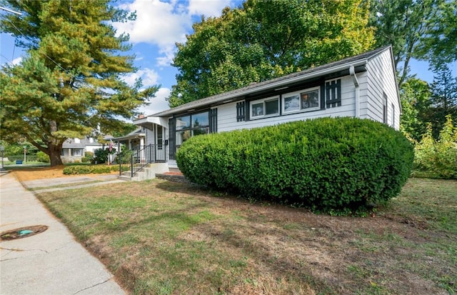 tri-level home with a front yard