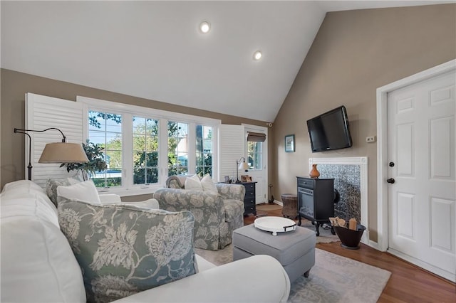 living room with lofted ceiling and hardwood / wood-style flooring