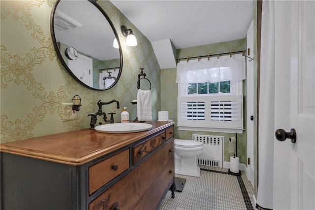 bathroom with radiator, toilet, tile patterned flooring, and vanity