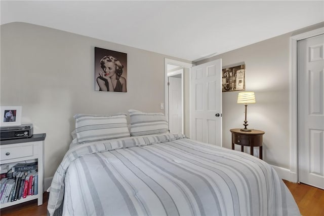 bedroom with dark hardwood / wood-style flooring