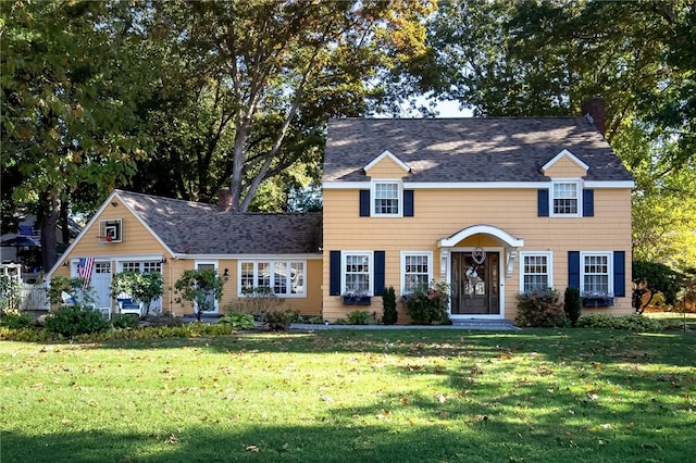 view of front of property with a garage and a front lawn