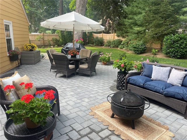 view of patio featuring grilling area and an outdoor living space with a fire pit