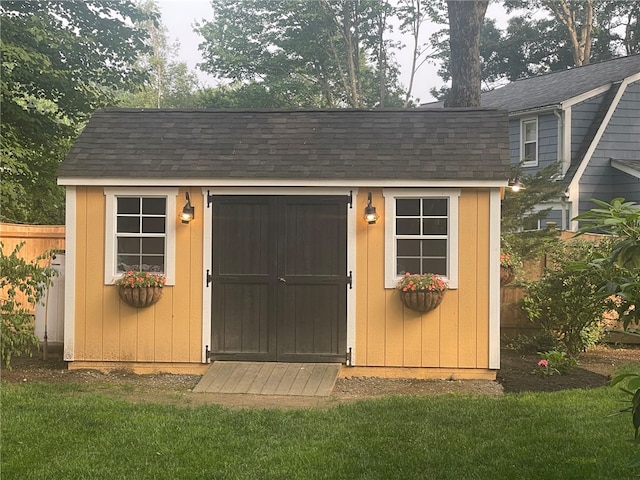 view of outbuilding featuring a yard