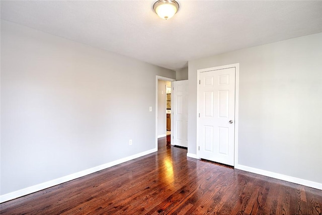 empty room featuring dark hardwood / wood-style flooring