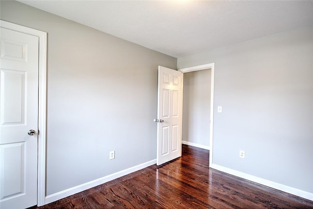 unfurnished bedroom featuring dark hardwood / wood-style floors