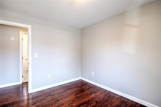 spare room featuring dark hardwood / wood-style floors