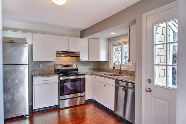 kitchen with appliances with stainless steel finishes, white cabinets, and sink