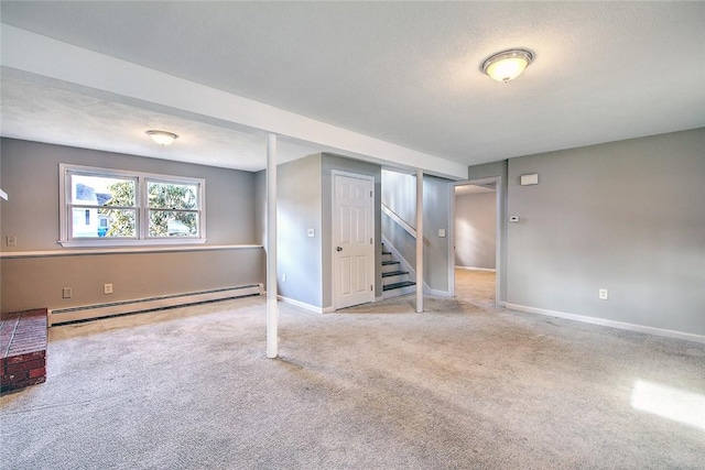 basement with carpet flooring and baseboard heating