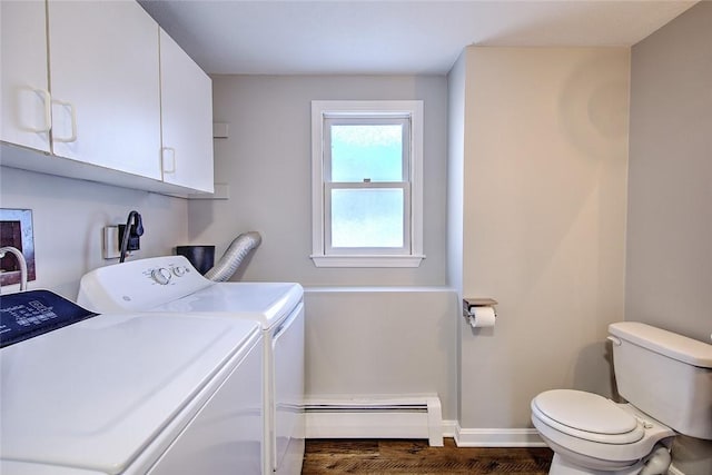 washroom with washing machine and clothes dryer, baseboard heating, and dark hardwood / wood-style floors