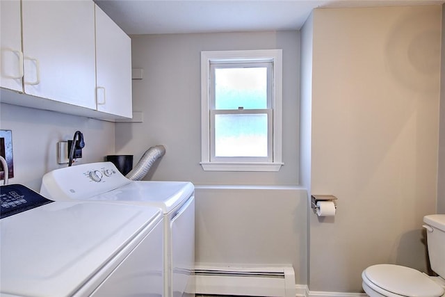 washroom featuring washer and dryer and a baseboard heating unit