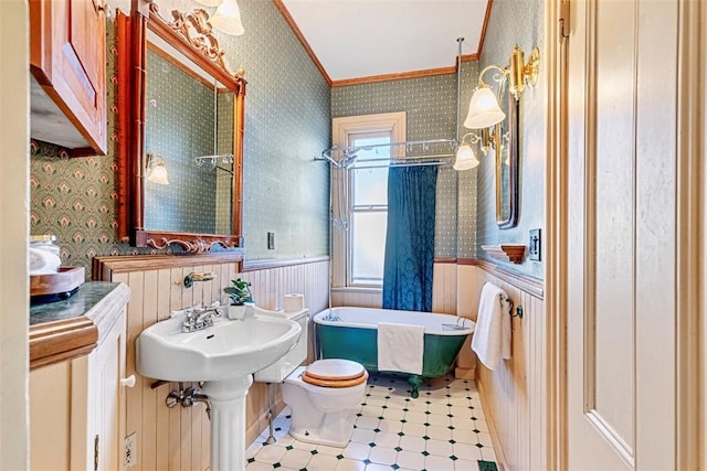 bathroom with toilet, a washtub, ornamental molding, and wood walls