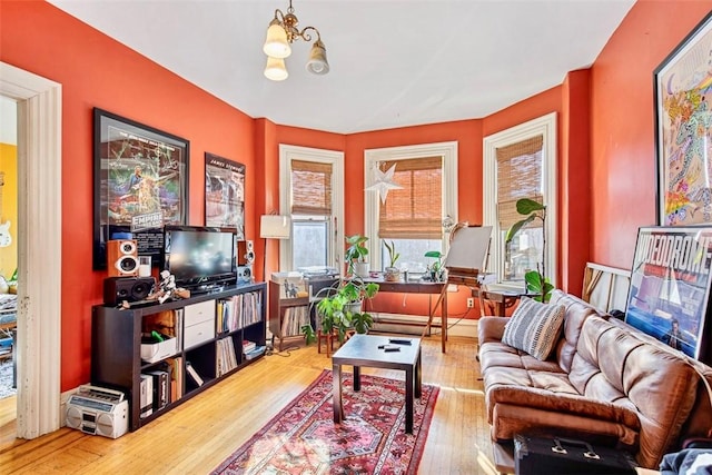 living room featuring wood-type flooring and a notable chandelier