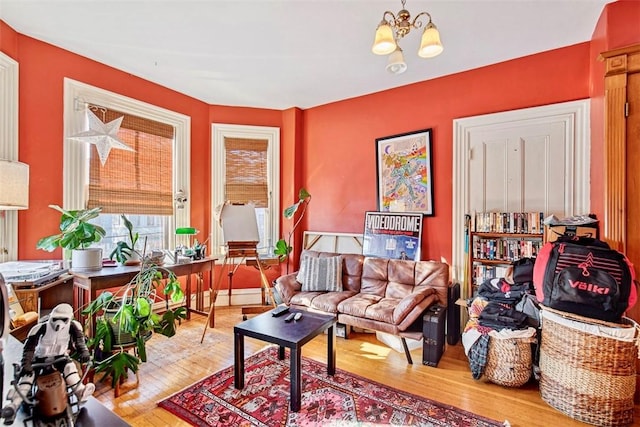 living room with hardwood / wood-style flooring and a notable chandelier