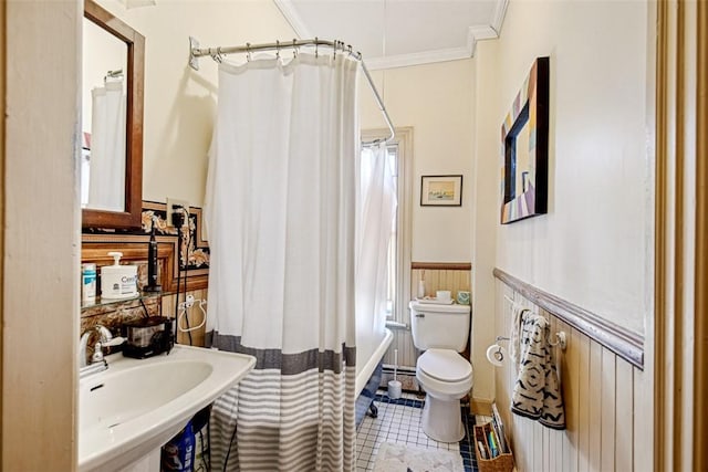 bathroom with toilet, a baseboard radiator, tile patterned flooring, ornamental molding, and sink