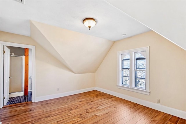 bonus room featuring lofted ceiling and light wood-type flooring