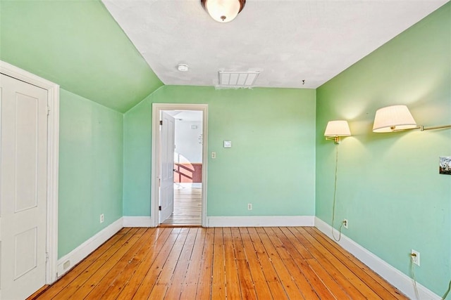 bonus room with light wood-type flooring and lofted ceiling