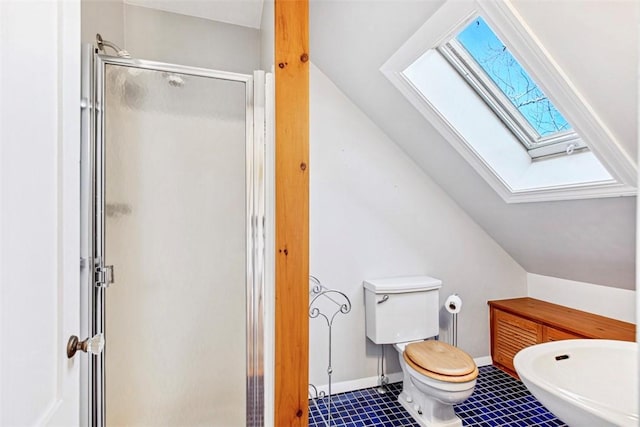 bathroom with toilet, a shower with door, lofted ceiling with skylight, and tile patterned floors