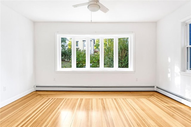 spare room featuring baseboard heating and ceiling fan