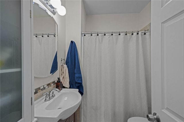 bathroom with vanity, decorative backsplash, and a shower with curtain