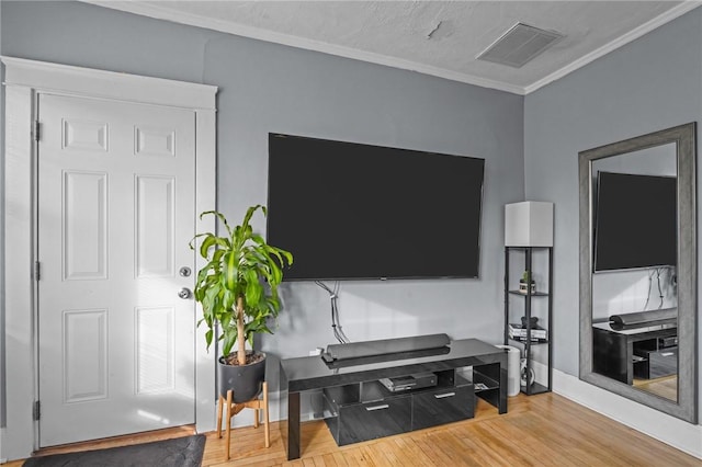 living room with crown molding and light hardwood / wood-style flooring