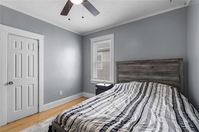 bedroom with wood-type flooring, ceiling fan, and ornamental molding