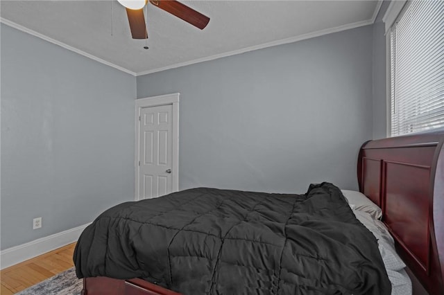 bedroom featuring ceiling fan, hardwood / wood-style flooring, and ornamental molding