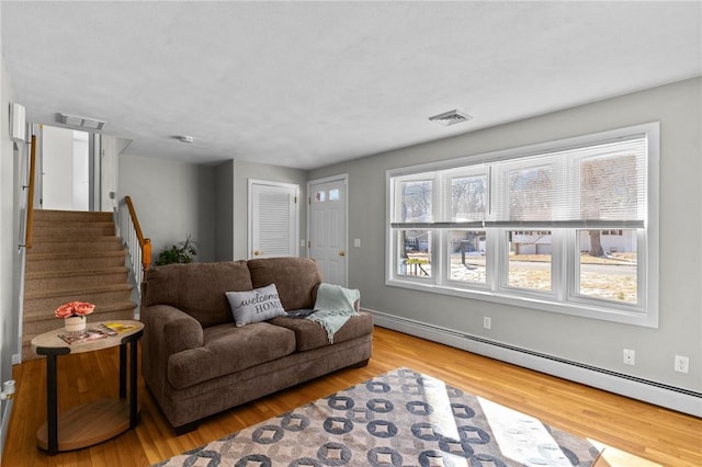 living room featuring a baseboard radiator and wood-type flooring