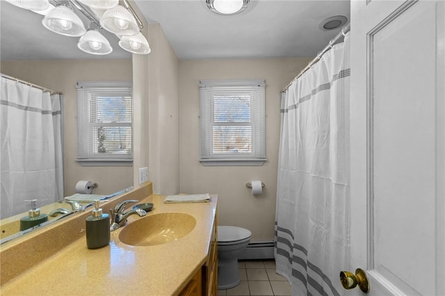 bathroom with vanity, plenty of natural light, tile patterned floors, and toilet