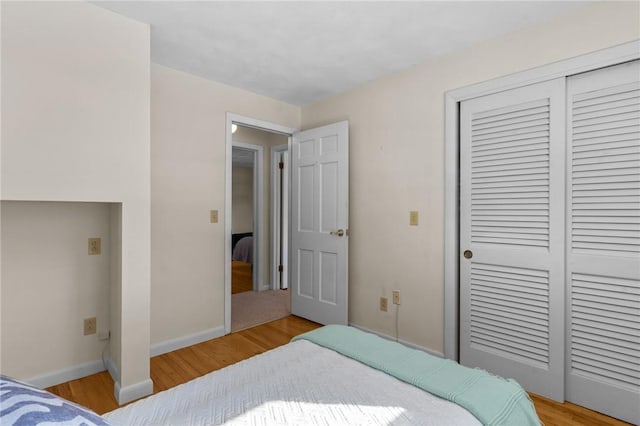 bedroom featuring a closet and light hardwood / wood-style flooring