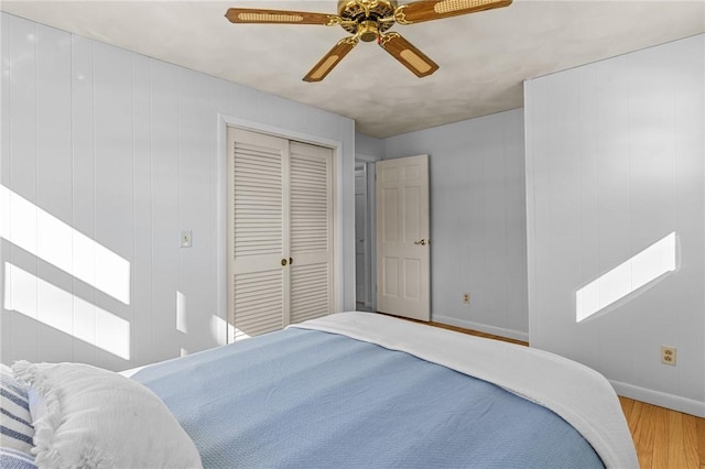 bedroom featuring a closet, ceiling fan, and light hardwood / wood-style flooring