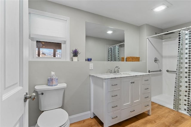 bathroom featuring hardwood / wood-style flooring, vanity, curtained shower, and toilet