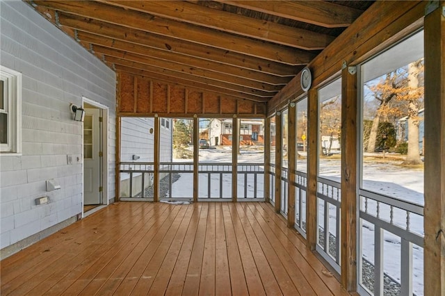 unfurnished sunroom featuring lofted ceiling