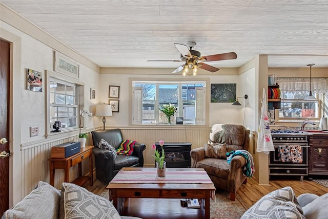 living room featuring ceiling fan, wooden walls, wooden ceiling, and wood-type flooring