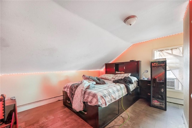 bedroom featuring vaulted ceiling and a baseboard heating unit