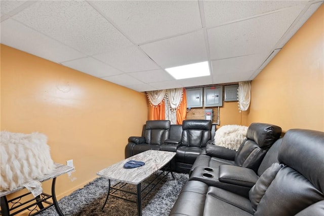 cinema room featuring carpet floors and a drop ceiling