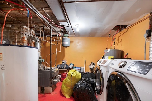 clothes washing area featuring water heater and separate washer and dryer