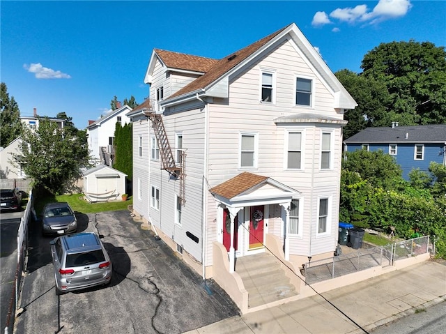 front of property with a storage shed