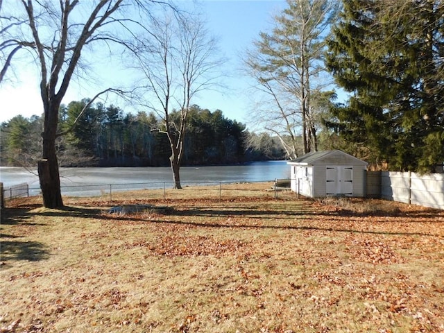 view of yard featuring a water view and a storage unit