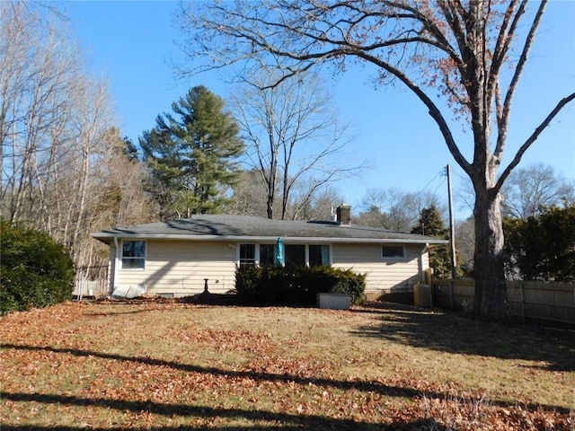 rear view of property with a lawn