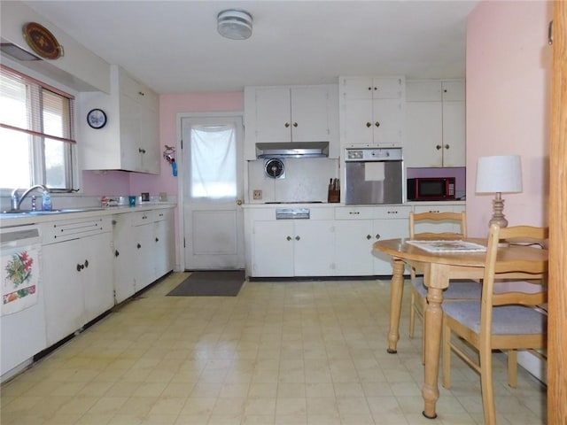 kitchen featuring sink, white cabinets, stainless steel oven, and dishwasher