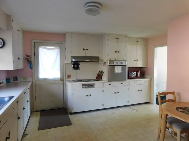 kitchen with white cabinets, white gas cooktop, and stainless steel oven