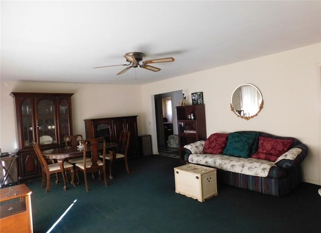 carpeted living room with ceiling fan