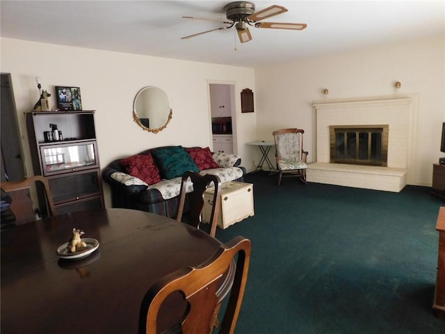 dining room featuring carpet flooring, a fireplace, and ceiling fan