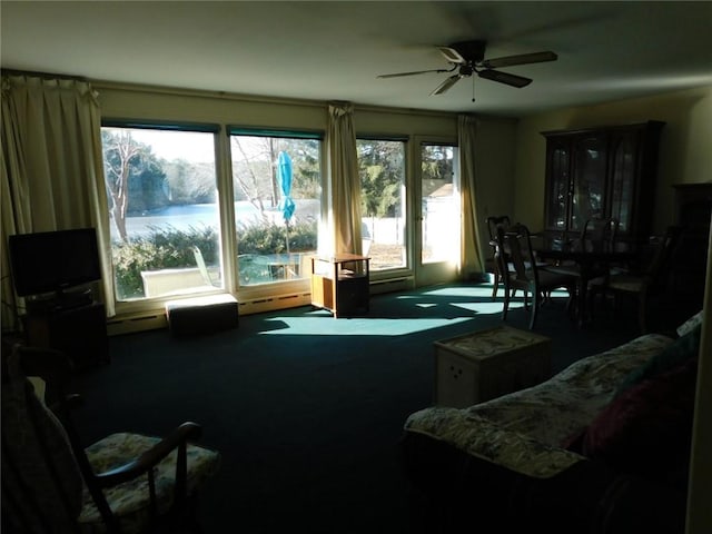 living room featuring baseboard heating, carpet floors, and ceiling fan