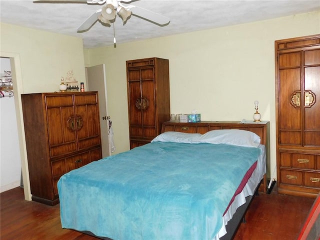 bedroom with ceiling fan and dark hardwood / wood-style floors